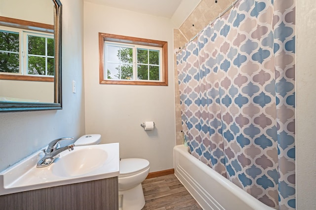 114 3rd Ave E, Truman, MN 56088 - bathroom featuring toilet, vanity, wood finished floors, baseboards, and shower / tub combo