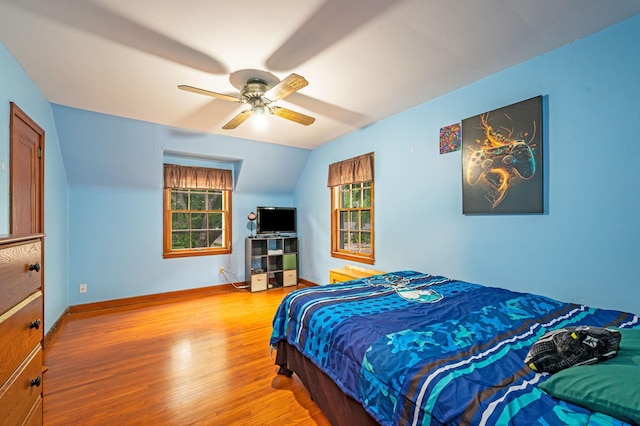 114 3rd Ave E, Truman, MN 56088 - bedroom featuring wood finished floors, baseboards, vaulted ceiling, and a ceiling fan