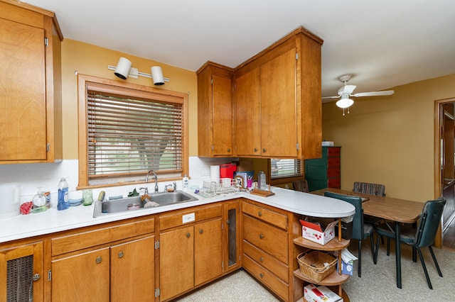 724 16th St NE, Rochester, MN 55906 - kitchen featuring a sink, ceiling fan, light countertops, and brown cabinets