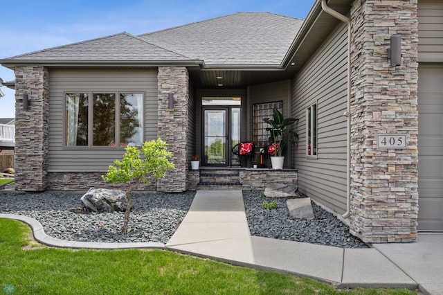 405 12th St NE, Dilworth, MN 56529 - property entrance featuring stone siding and a shingled roof