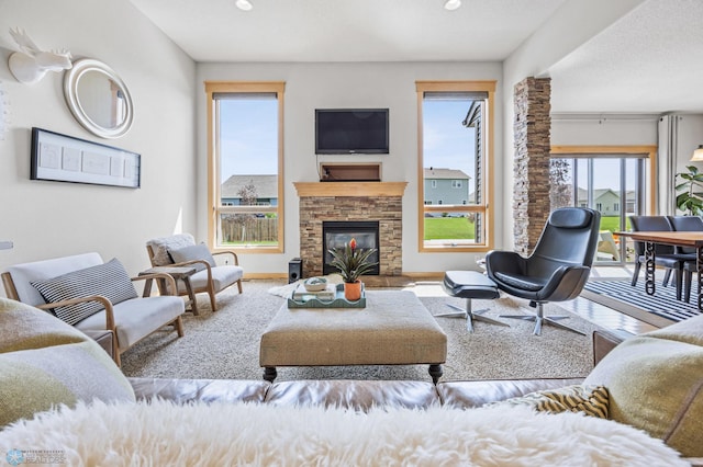 405 12th St NE, Dilworth, MN 56529 - living area featuring a stone fireplace, baseboards, and recessed lighting