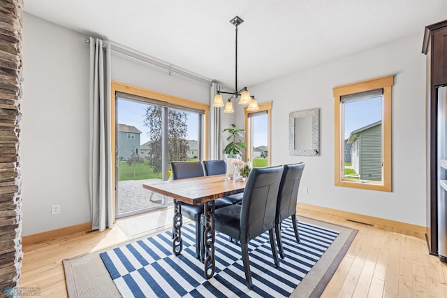 405 12th St NE, Dilworth, MN 56529 - dining room featuring baseboards and light wood-style flooring