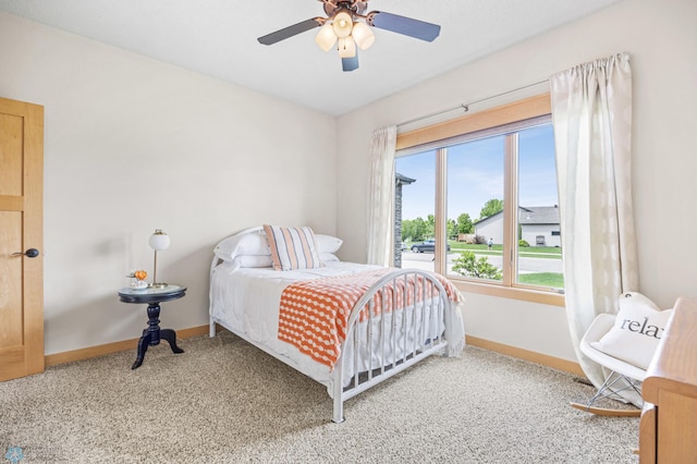 405 12th St NE, Dilworth, MN 56529 - bedroom with baseboards, light carpet, and ceiling fan