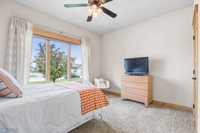 405 12th St NE, Dilworth, MN 56529 - bedroom featuring baseboards, light carpet, and ceiling fan