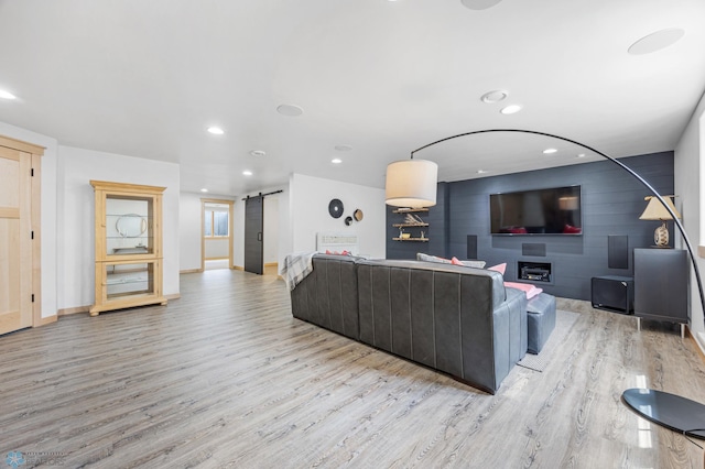405 12th St NE, Dilworth, MN 56529 - living area with a barn door, light wood-type flooring, baseboards, and recessed lighting