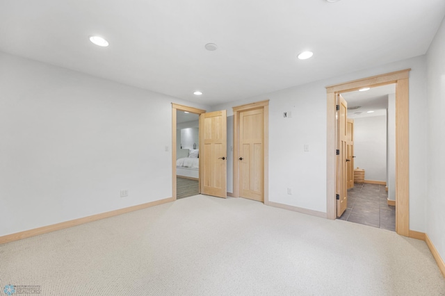 405 12th St NE, Dilworth, MN 56529 - unfurnished bedroom with light colored carpet, recessed lighting, baseboards, and ensuite bathroom