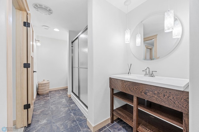 405 12th St NE, Dilworth, MN 56529 - bathroom featuring baseboards, a shower stall, and vanity