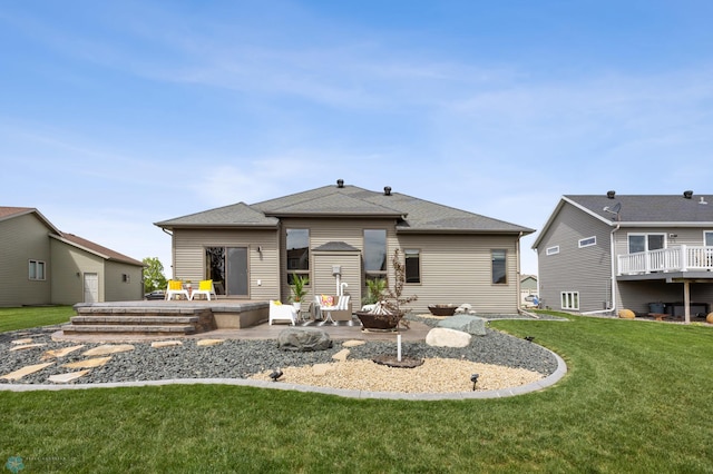 405 12th St NE, Dilworth, MN 56529 - back of property with a patio, a lawn, and an outdoor fire pit