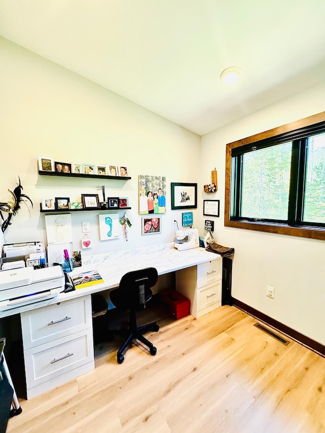 30710 County Road 45, Marcell Twp, MN 56628 - home office featuring built in study area, light wood-style floors, and baseboards