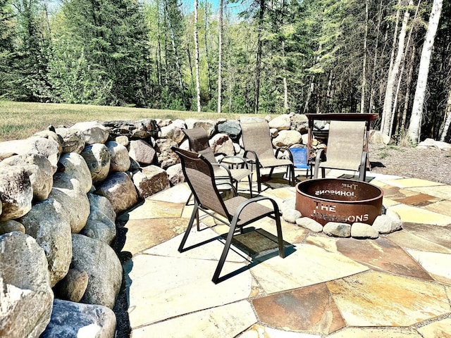 30710 County Road 45, Marcell Twp, MN 56628 - view of patio / terrace featuring an outdoor fire pit and a view of trees