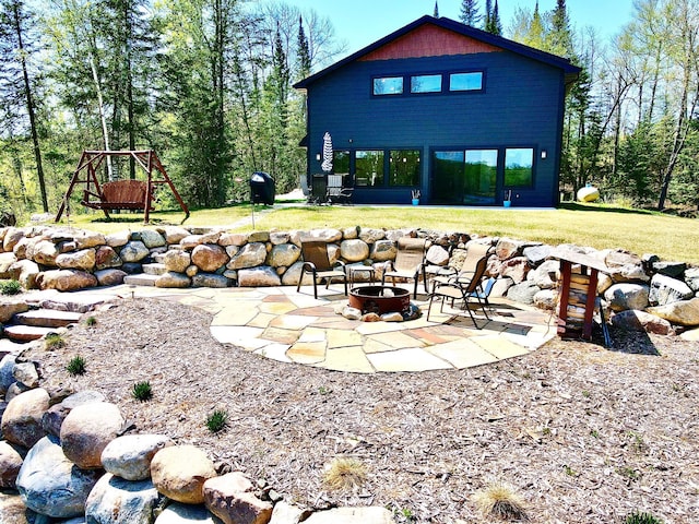 30710 County Road 45, Marcell Twp, MN 56628 - back of house featuring an outdoor fire pit, a patio, and a yard
