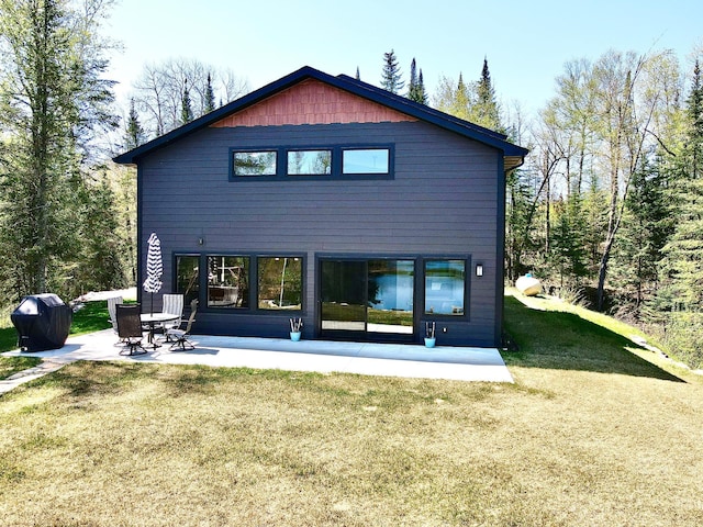 30710 County Road 45, Marcell Twp, MN 56628 - back of house featuring a patio area and a yard