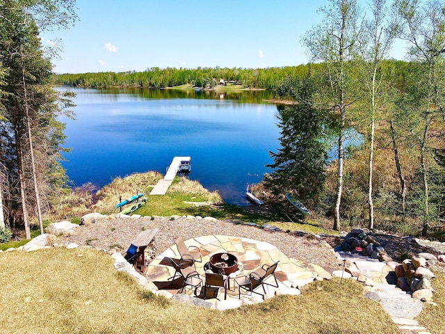 30710 County Road 45, Marcell Twp, MN 56628 - dock with a fire pit, a water view, and a wooded view