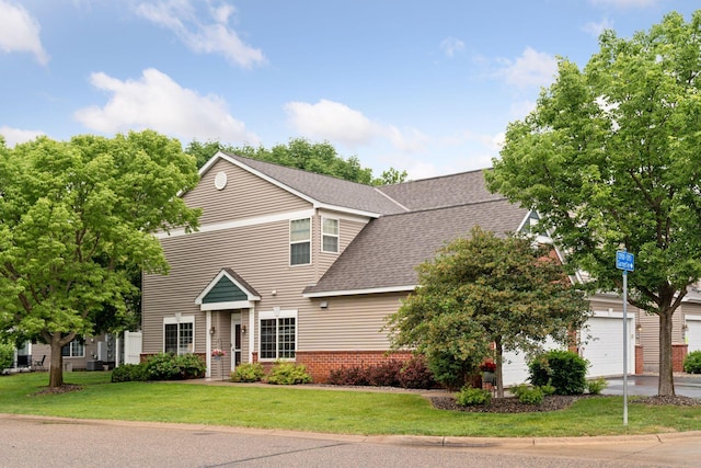 13900 Garnet Ter NW, Anoka, MN 55303 - view of front of property with a front yard, a shingled roof, a garage, and brick siding