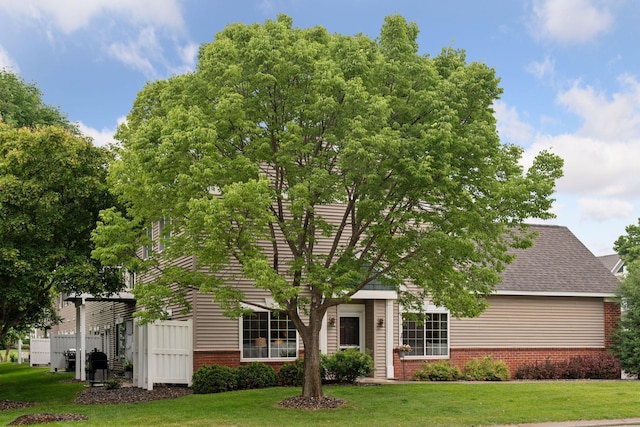 13900 Garnet Ter NW, Ramsey, MN 55303 - obstructed view of property with brick siding and a front lawn