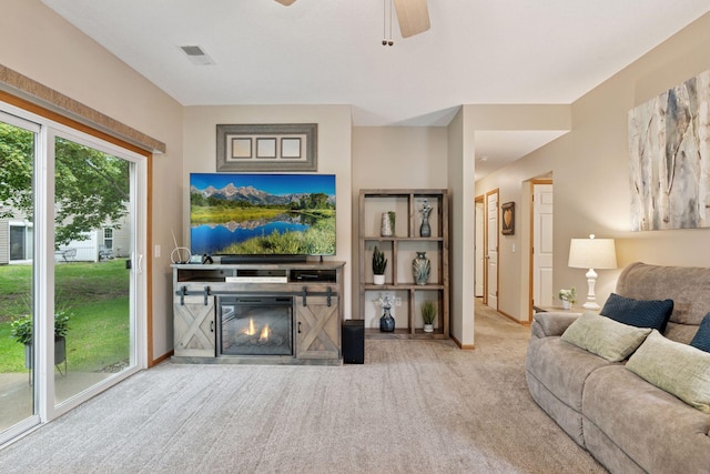 13900 Garnet Ter NW, Ramsey, MN 55303 - living room featuring carpet floors, a glass covered fireplace, and ceiling fan