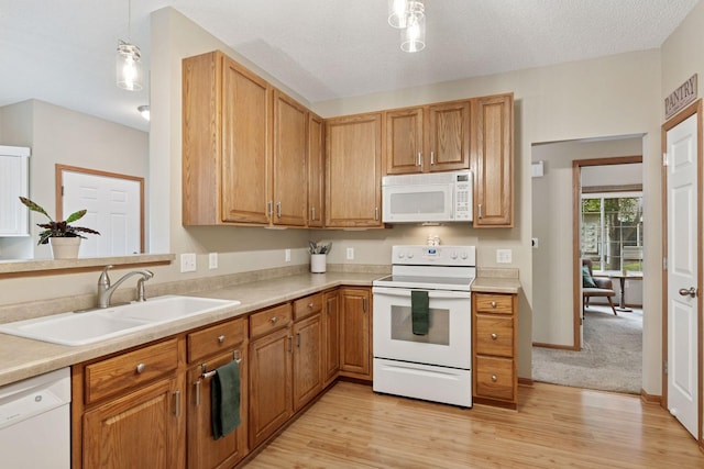 13900 Garnet Ter NW, Ramsey, MN 55303 - kitchen with white appliances, light wood finished floors, light countertops, and brown cabinets