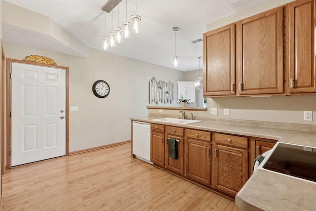 13900 Garnet Ter NW, Ramsey, MN 55303 - kitchen with dishwasher, brown cabinets, light wood-style flooring, hanging light fixtures, and light countertops
