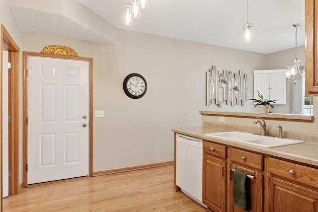13900 Garnet Ter NW, Ramsey, MN 55303 - kitchen with white dishwasher, light wood finished floors, light countertops, and brown cabinets