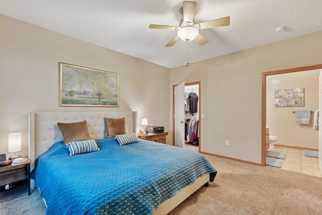 13900 Garnet Ter NW, Ramsey, MN 55303 - bedroom featuring a spacious closet, light carpet, ensuite bathroom, ceiling fan, and a closet