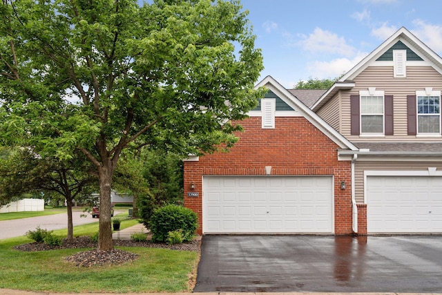13900 Garnet Ter NW, Ramsey, MN 55303 - view of front of property featuring brick siding, driveway, an attached garage, and a shingled roof