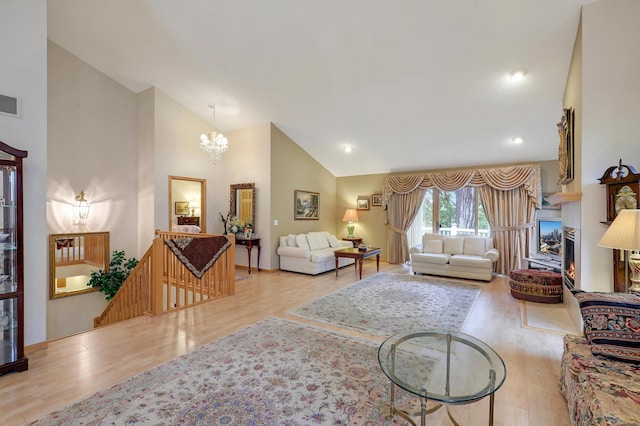 8207 Norman Creek Trl, Bloomington, MN 55437 - living room featuring wood finished floors, a chandelier, high vaulted ceiling, and recessed lighting