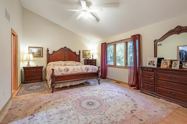 8207 Norman Creek Trl, Bloomington, MN 55437 - bedroom with lofted ceiling, light wood-type flooring, baseboards, and a ceiling fan
