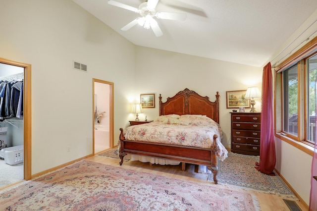 8207 Norman Creek Trl, Bloomington, MN 55437 - bedroom with light wood-type flooring, baseboards, ensuite bath, ceiling fan, and high vaulted ceiling