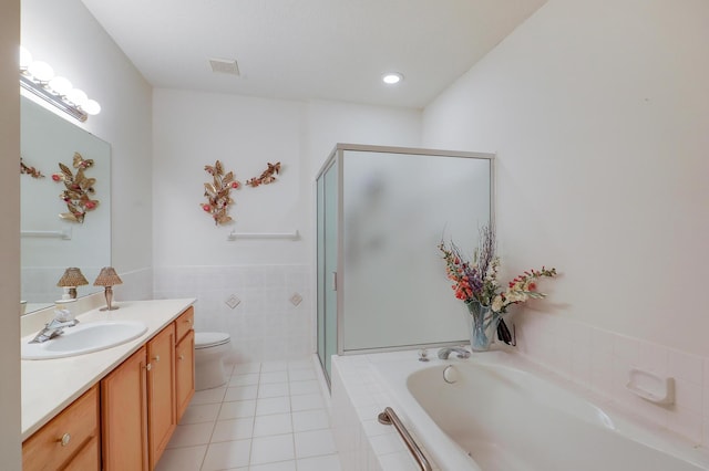 8207 Norman Creek Trl, Bloomington, MN 55437 - bathroom with vanity, a bath, a stall shower, tile patterned flooring, and tile walls