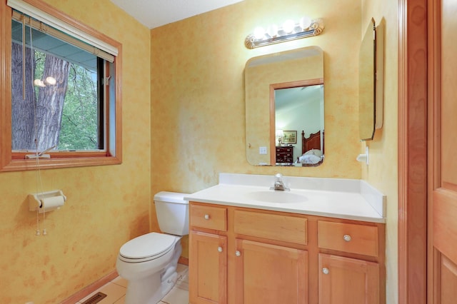 8207 Norman Creek Trl, Bloomington, MN 55437 - bathroom with toilet, vanity, and tile patterned floors