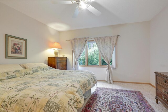 8207 Norman Creek Trl, Bloomington, MN 55437 - bedroom with light colored carpet, baseboards, and ceiling fan
