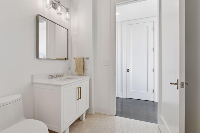 1111 River Pkwy Unit 24C, Minneapolis, MN 55415 - bathroom featuring vanity, toilet, and baseboards