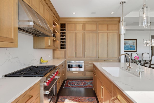 1111 River Pkwy Unit 24C, Minneapolis, MN 55415 - kitchen with under cabinet range hood, stainless steel appliances, dark wood finished floors, decorative light fixtures, and recessed lighting