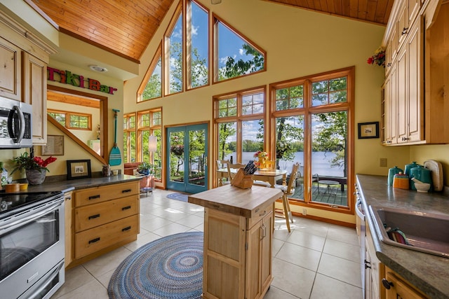 209 9 1/2 Ave, Turtle Lake, WI 54889 - kitchen with appliances with stainless steel finishes, wooden ceiling, butcher block counters, high vaulted ceiling, and light tile patterned floors