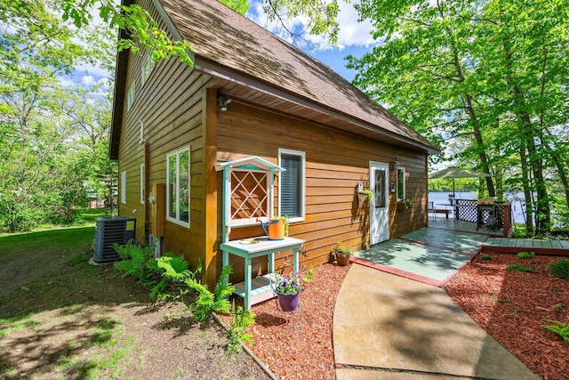 209 9 1/2 Ave, Turtle Lake, WI 54889 - view of side of home featuring central AC unit and roof with shingles