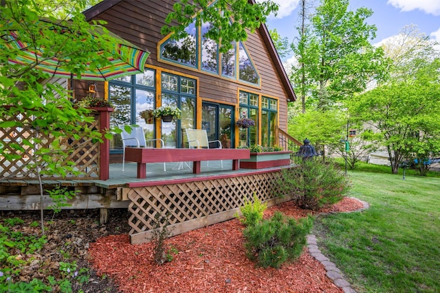 209 9 1/2 Ave, Turtle Lake, WI 54889 - back of property with a deck and a lawn