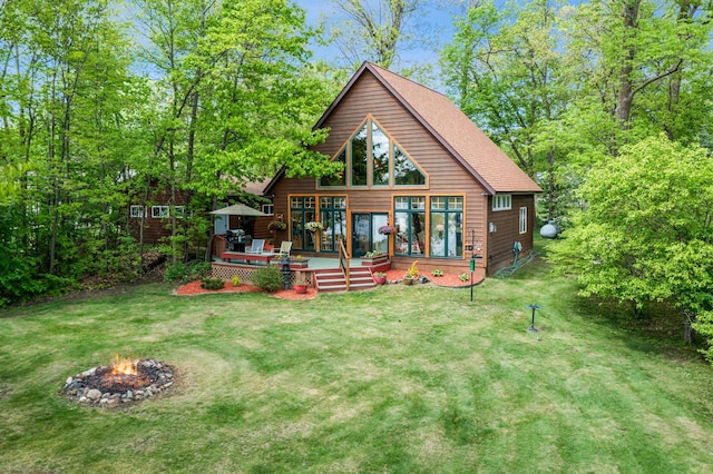 209 9 1/2 Ave, Turtle Lake, WI 54889 - back of house featuring a fire pit, a wooden deck, a lawn, and a shingled roof