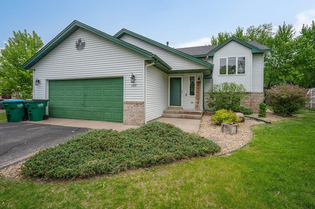 604 Brookview Ln SW, Isanti, MN 55040 - split level home with brick siding, driveway, a garage, and a front lawn