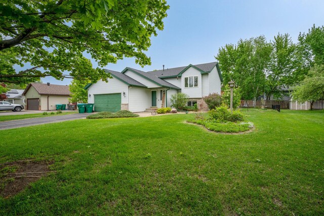 604 Brookview Ln SW, Isanti, MN 55040 - tri-level home with asphalt driveway, a garage, and brick siding