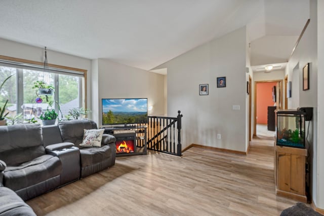 604 Brookview Ln SW, Isanti, MN 55040 - living room featuring vaulted ceiling, light wood-type flooring, and baseboards
