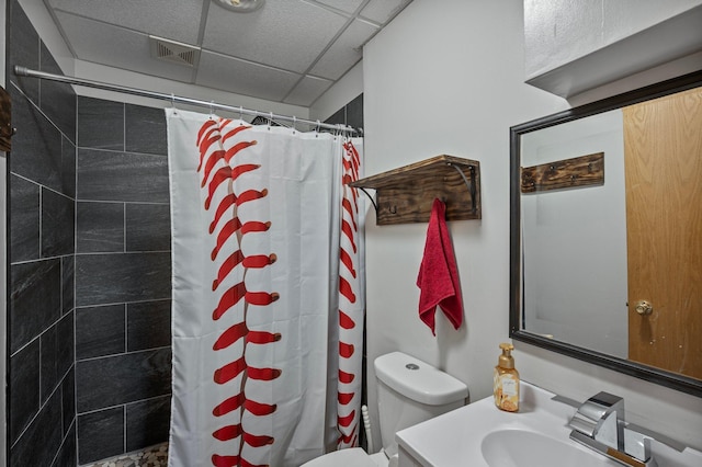 604 Brookview Ln SW, Isanti, MN 55040 - full bath with toilet, a tile shower, a paneled ceiling, and vanity