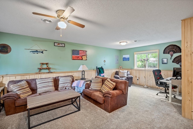 604 Brookview Ln SW, Isanti, MN 55040 - carpeted living room with a wainscoted wall, a textured ceiling, an office area, ceiling fan, and wooden walls