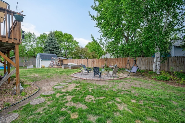 604 Brookview Ln SW, Isanti, MN 55040 - view of yard featuring a fire pit, a deck, and a patio area