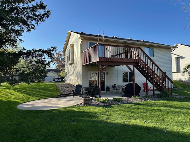 rear view of house with a patio area, a lawn, a wooden deck, and stairway