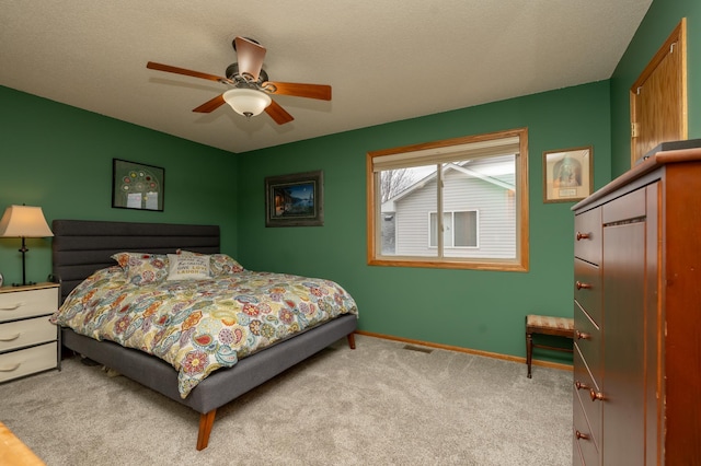 carpeted bedroom with baseboards and ceiling fan