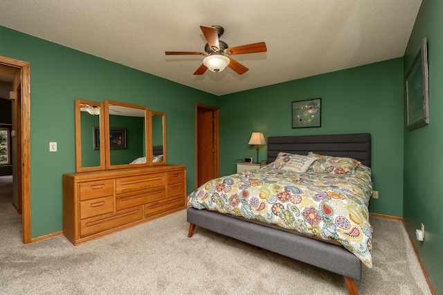 bedroom with carpet, a closet, ceiling fan, and baseboards