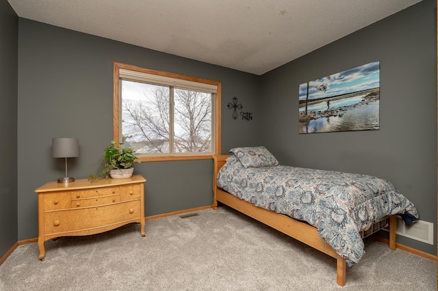 carpeted bedroom featuring baseboards