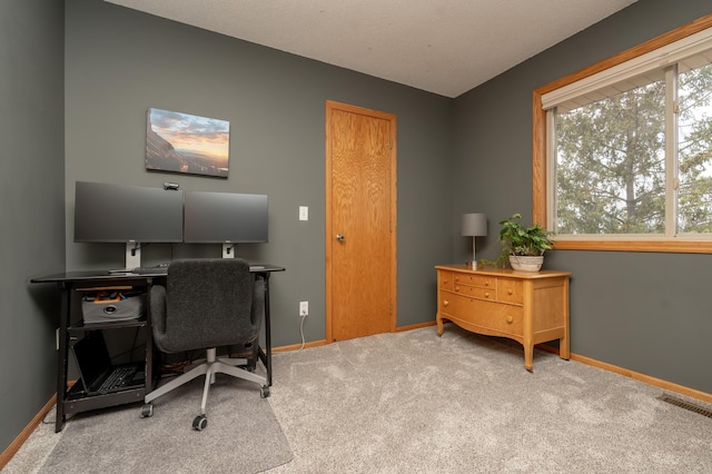 home office with baseboards and carpet flooring