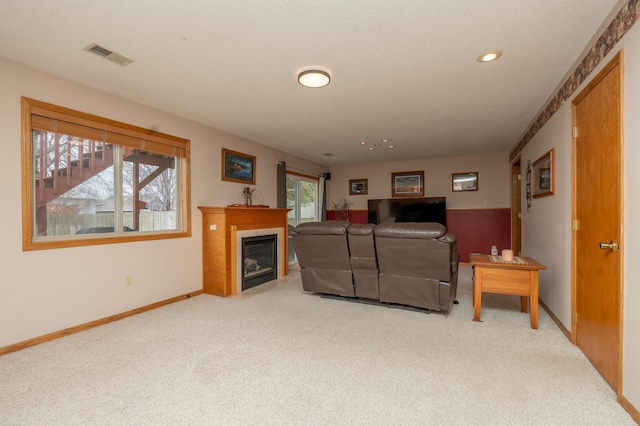 living area featuring carpet flooring, baseboards, a tile fireplace, and recessed lighting
