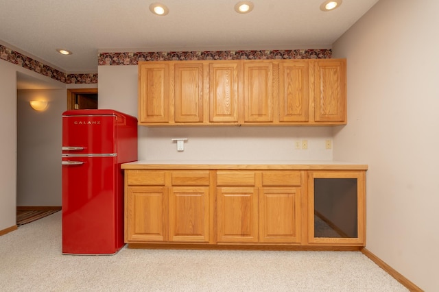 kitchen with freestanding refrigerator, light colored carpet, recessed lighting, light countertops, and baseboards